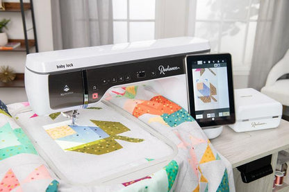 Baby Lock Radiance sewing and embroidery machine showcasing its large embroidery hoop while stitching an intricate design onto a quilt. Linda's Quilt Shoppe